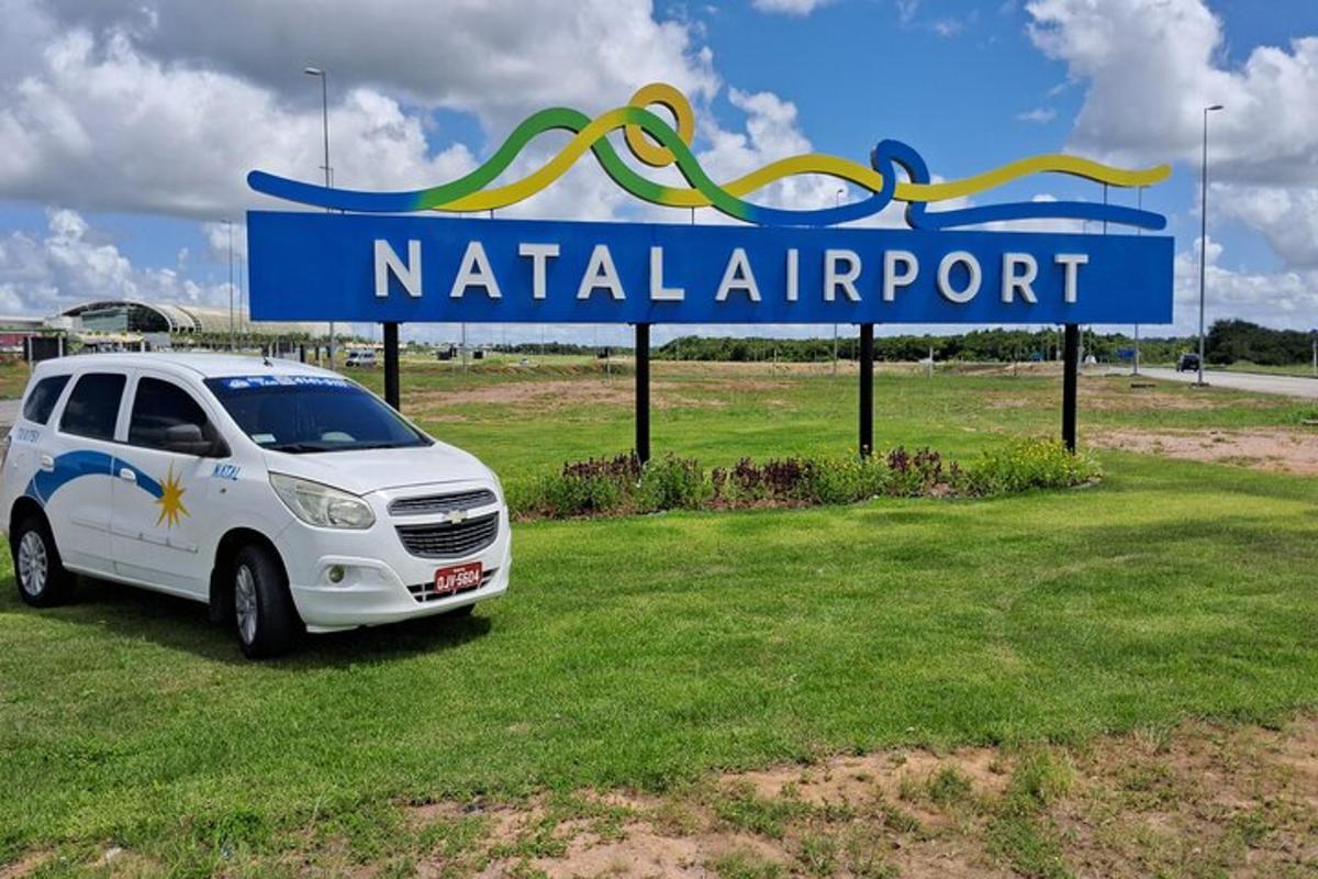 a white van parked in front of a sign
