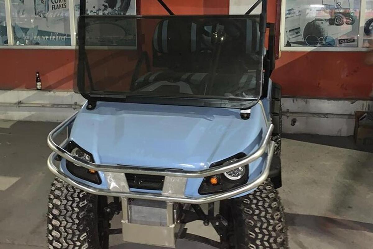 a front view of a golf cart parked in a garage