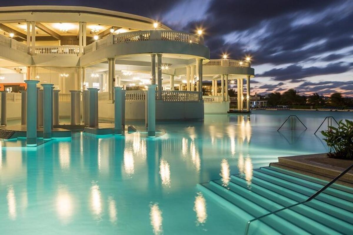 a large building with a swimming pool at night