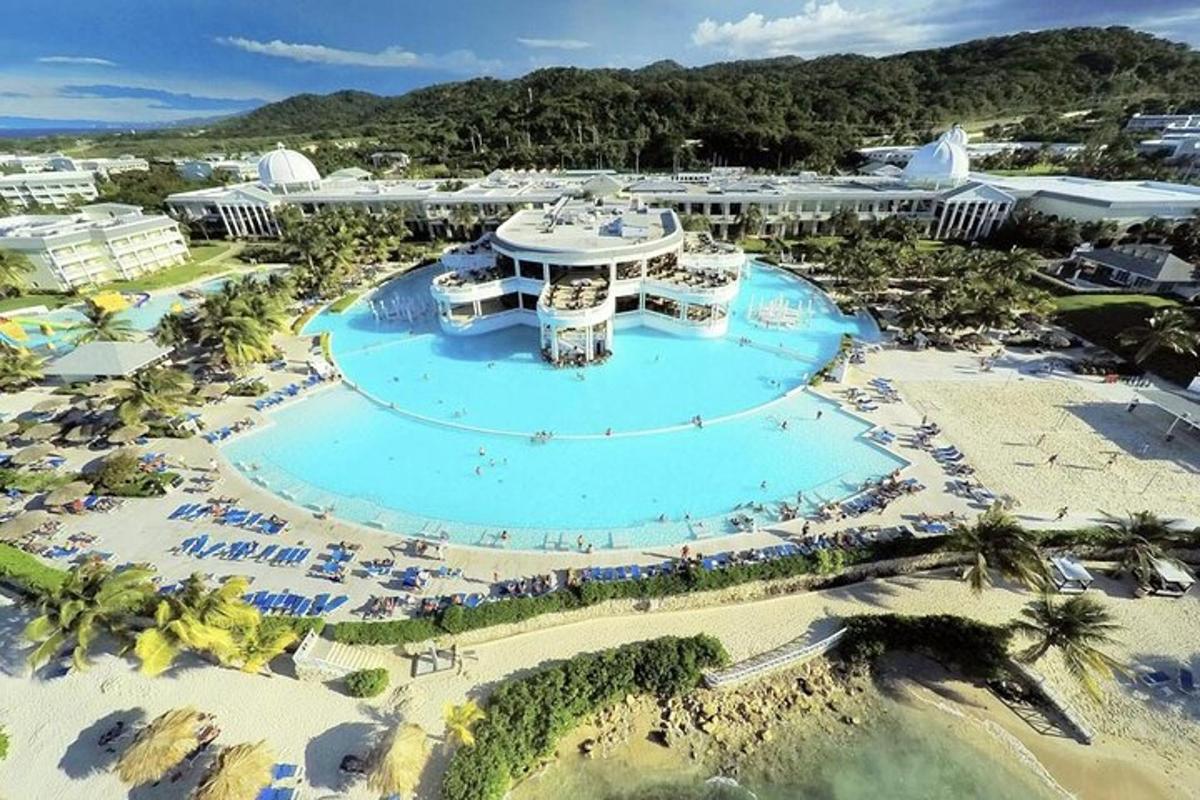 an aerial view of a resort with a pool