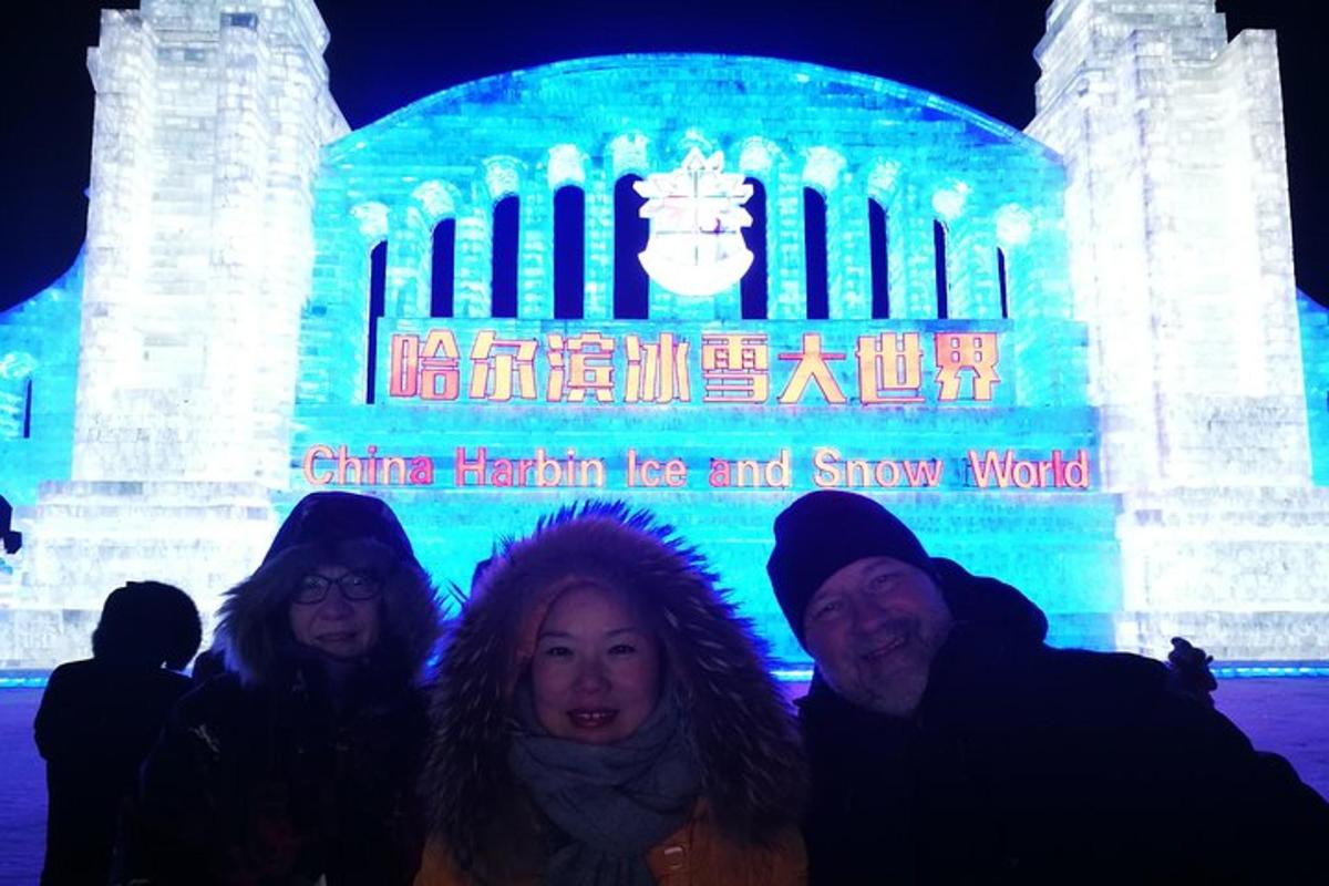a group of people standing in front of a ice and snow world