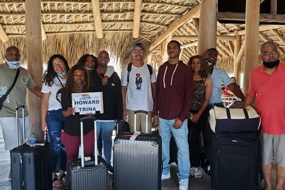 a group of people posing for a picture with their luggage