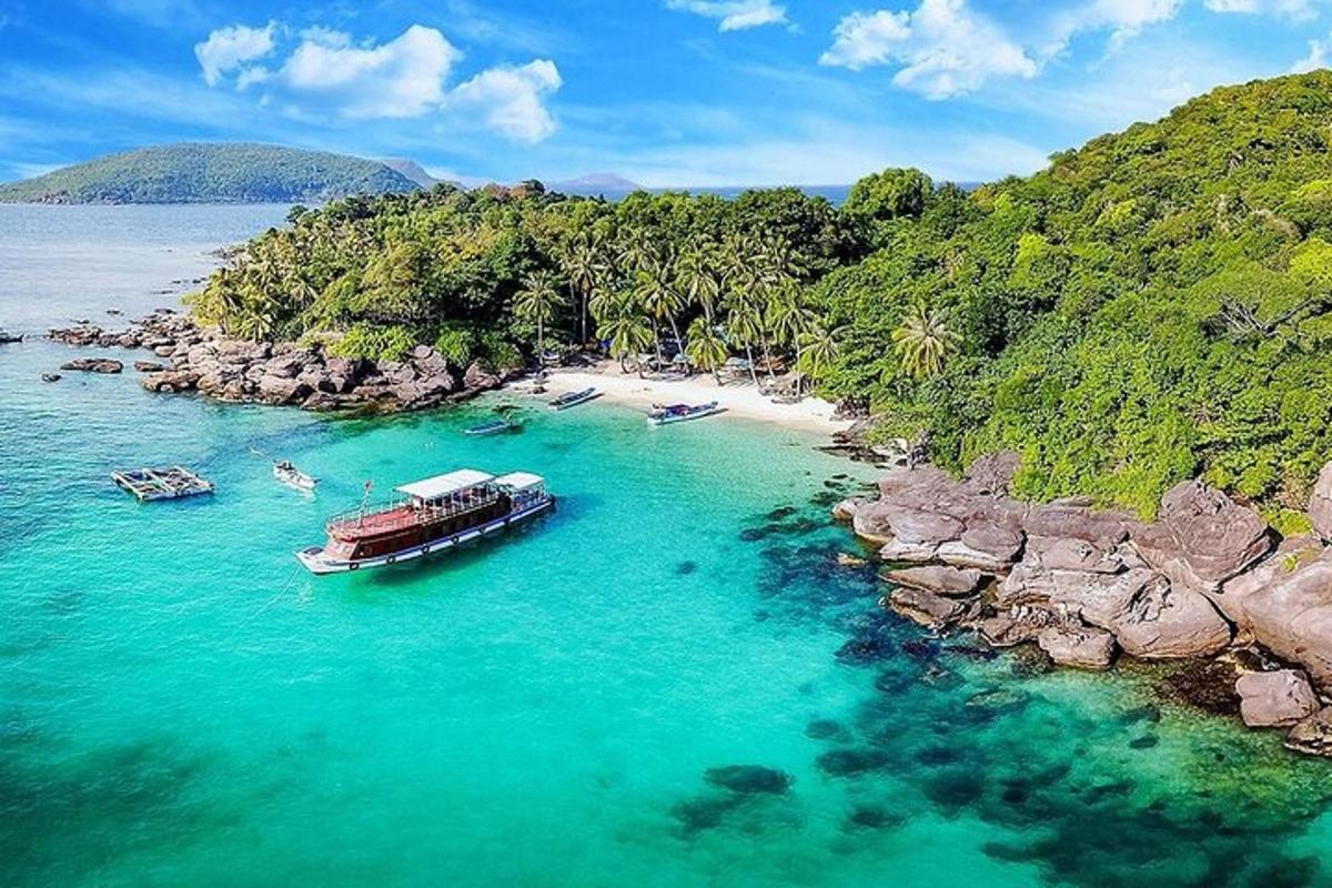 a boat in the water next to a beach