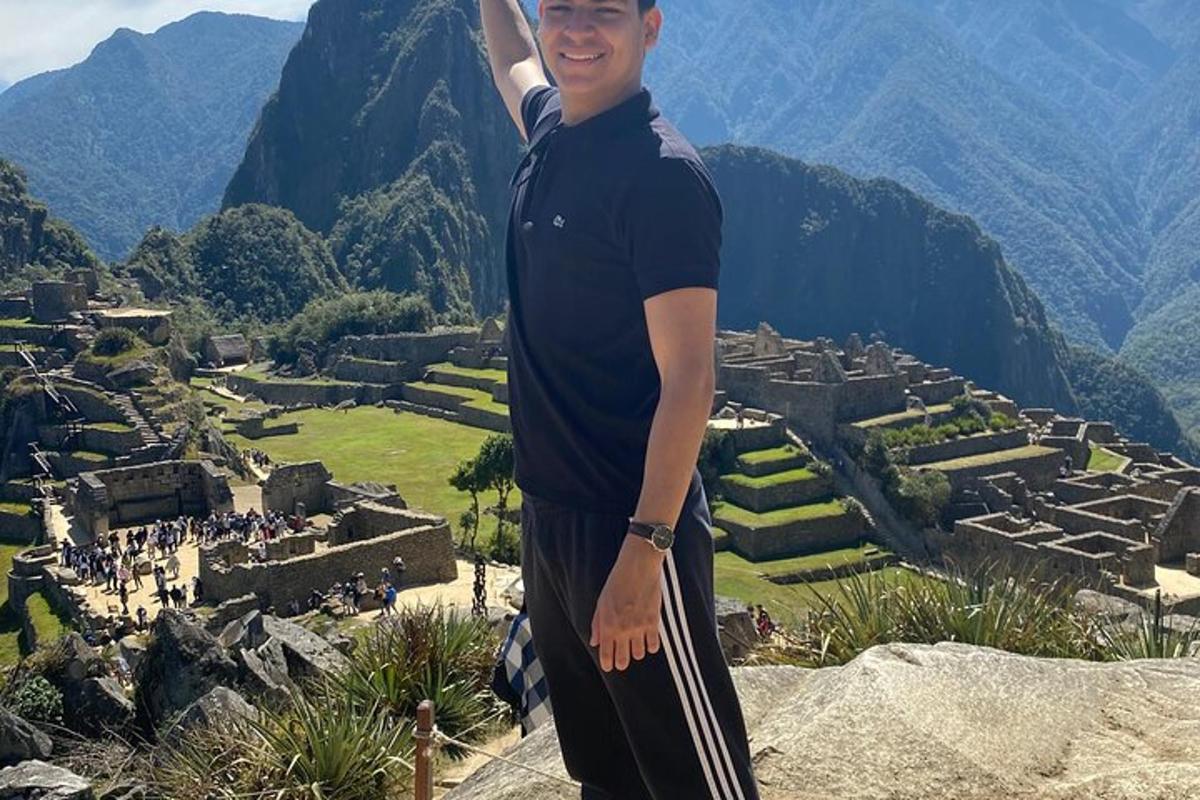 a man is standing on top of a mountain