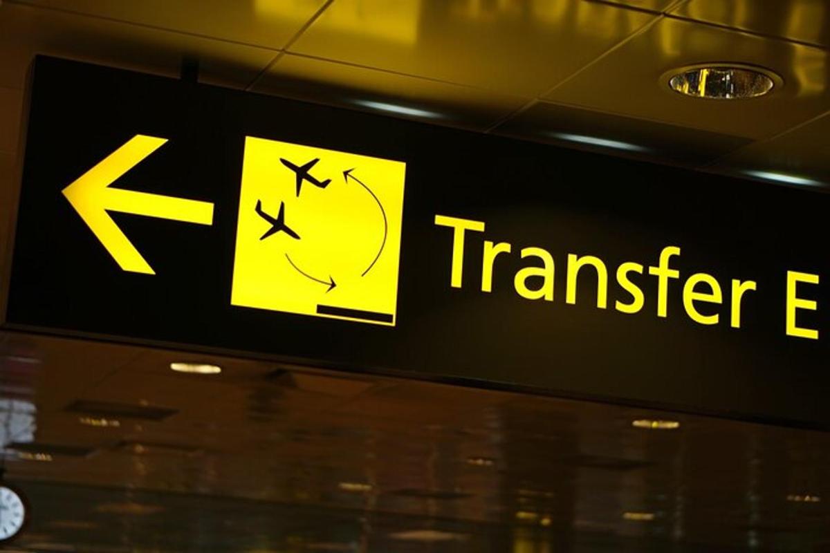 ein Transferagentenschild an der Wand eines Flughafens