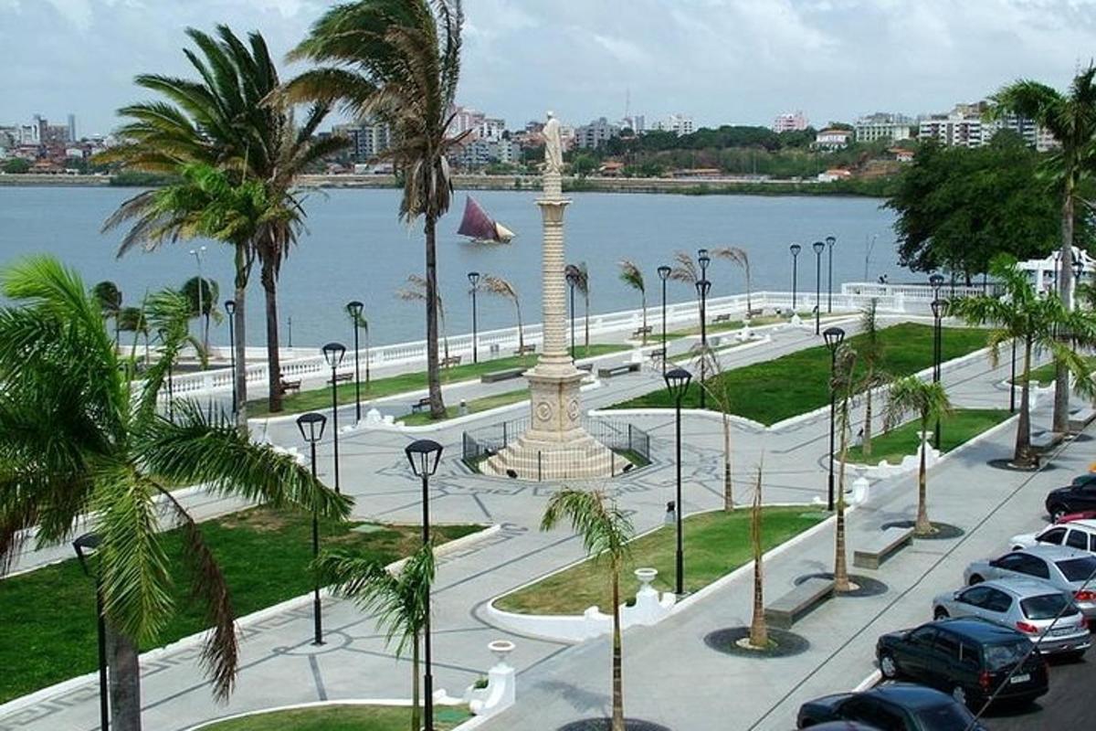 a parking lot with a monument in front of the water