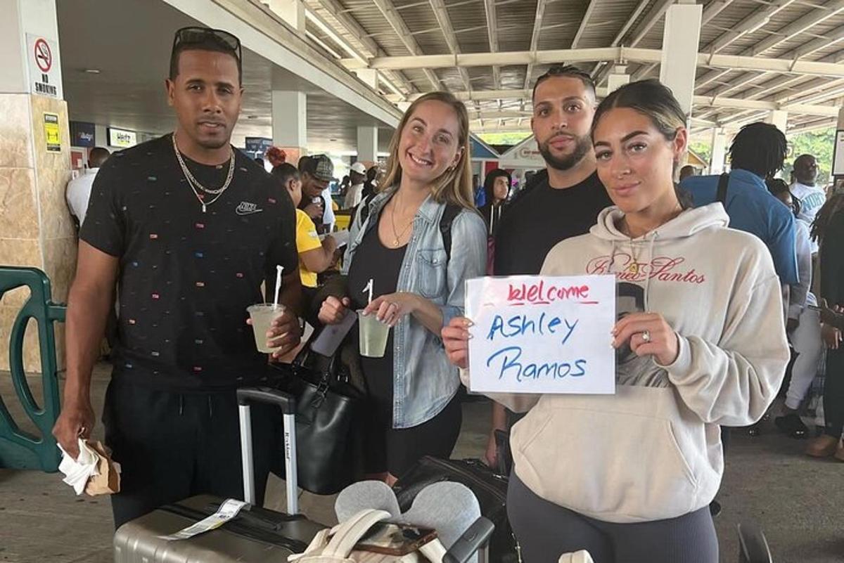 a group of people holding a sign at an airport