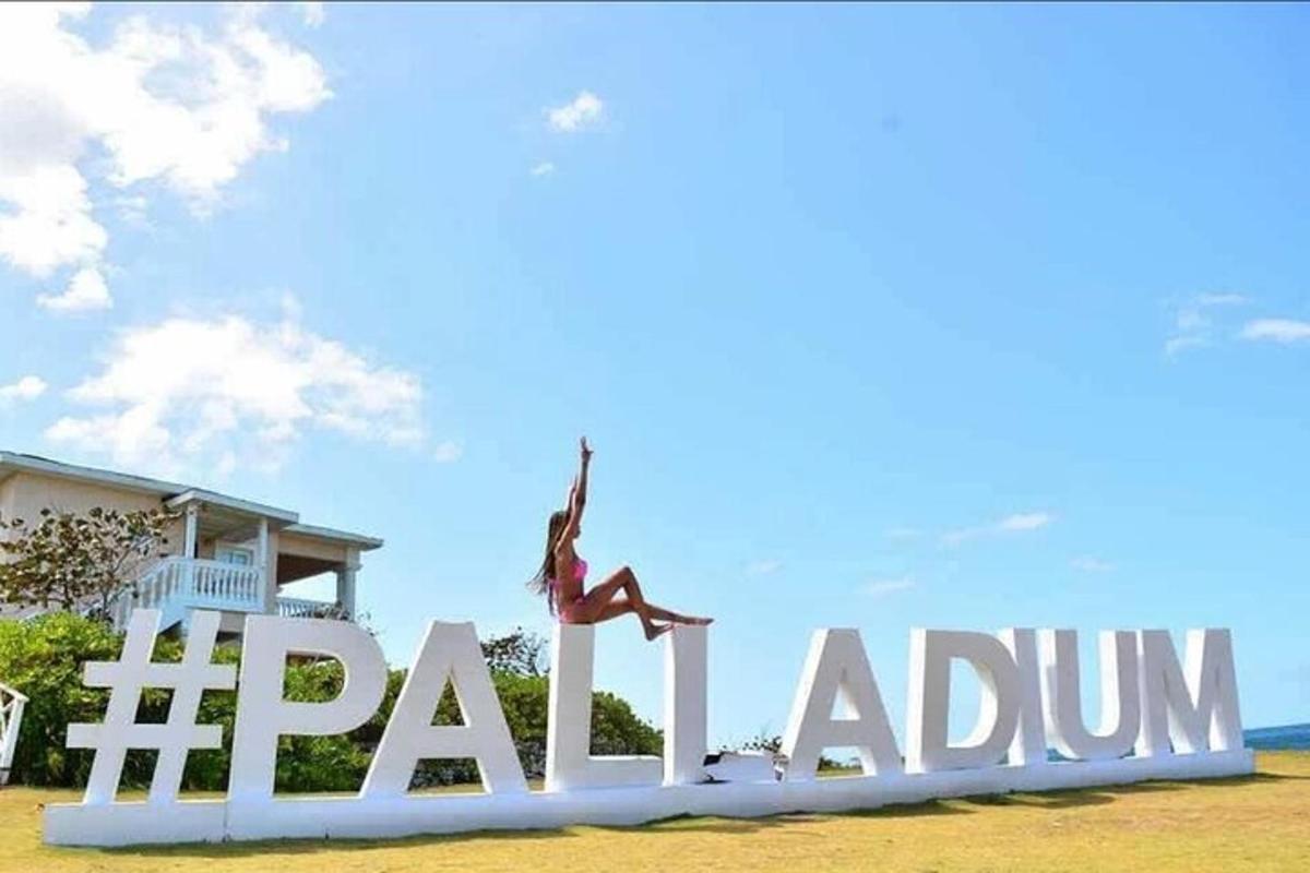 a woman dancing on top of a large sign