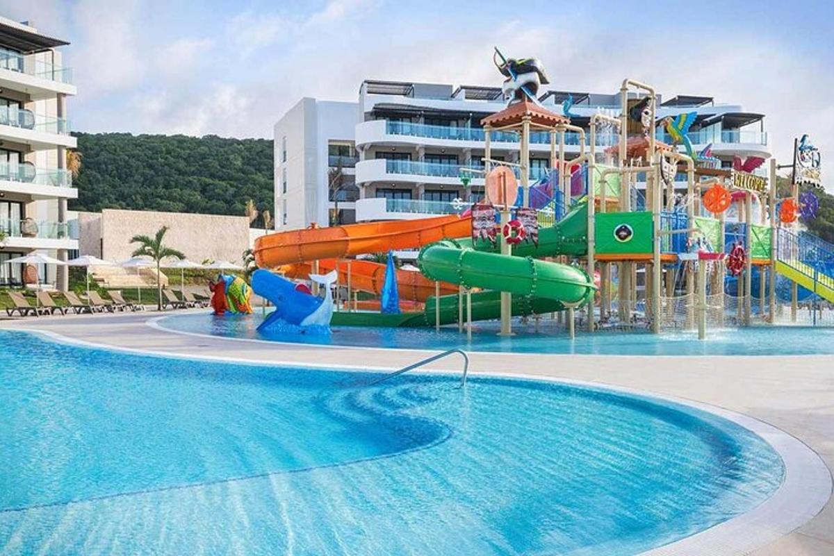 μια μεγάλη πισίνα με υδάτινο πάρκο με νεροτσουλήθρα