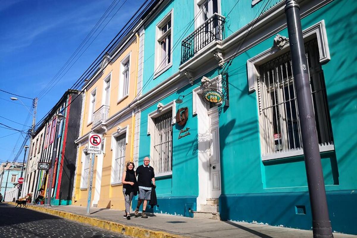 a man and woman standing in front of a blue building