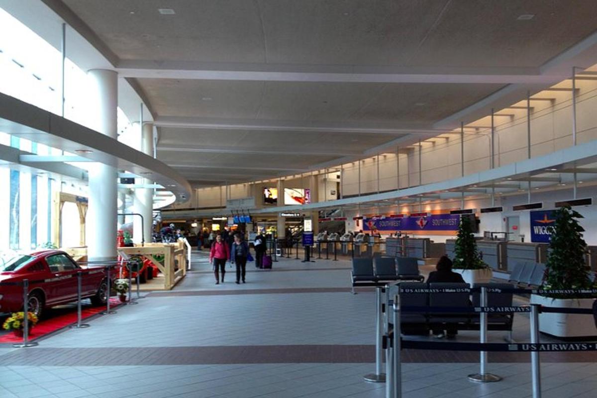 an airport with people walking around a mall