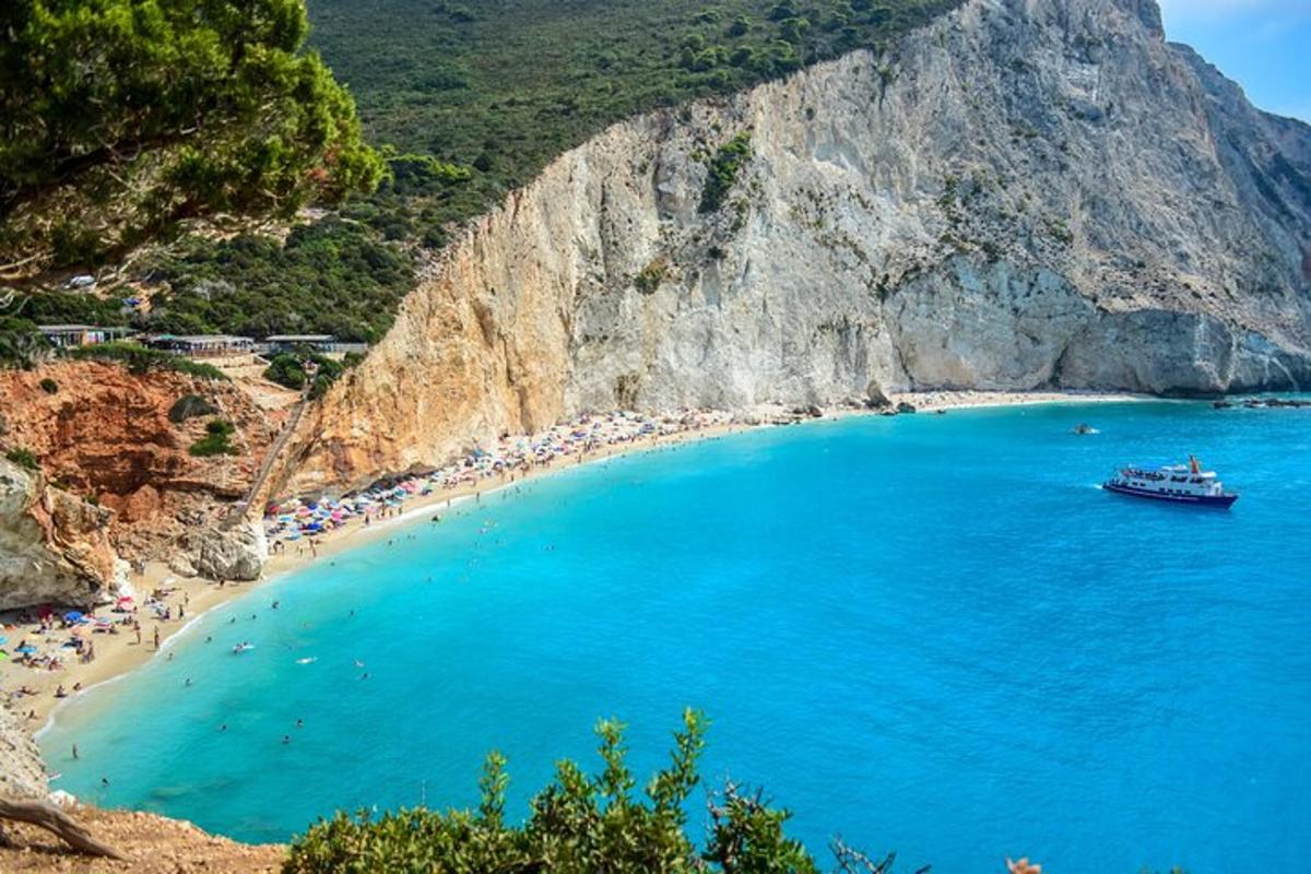 a beach with people and a boat in the water