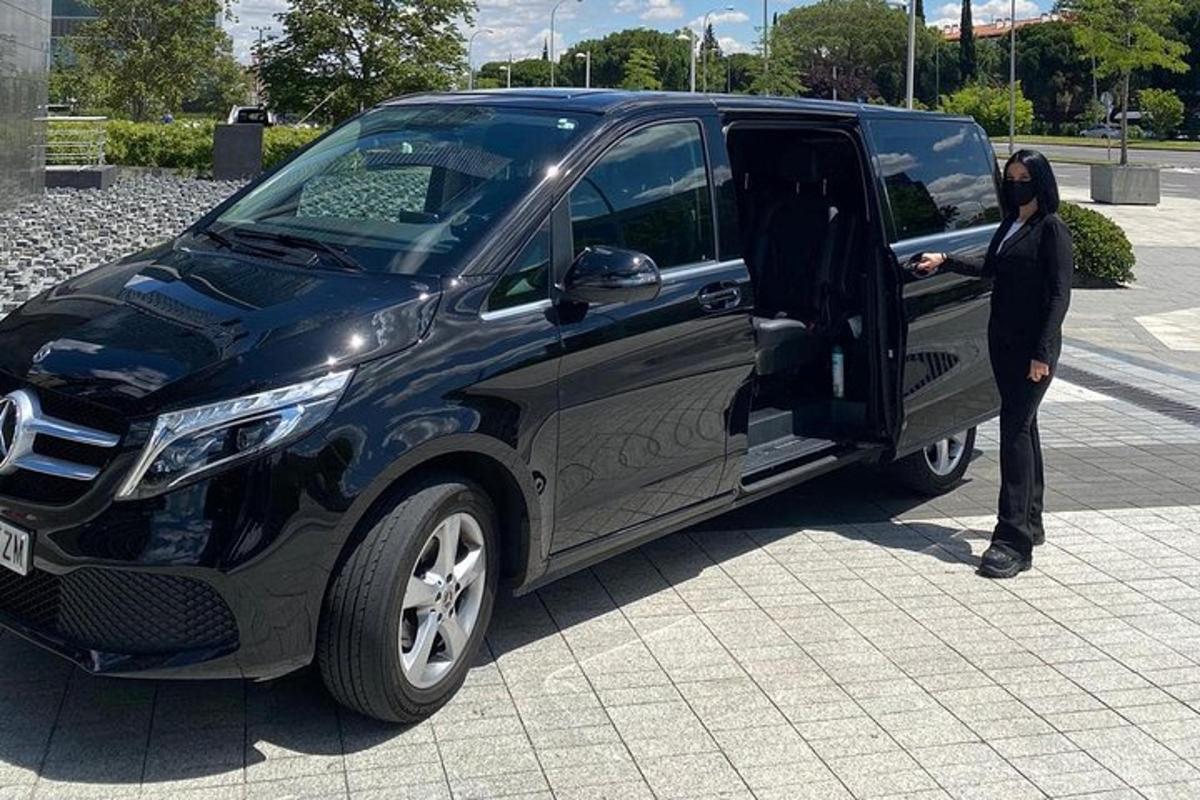 a man standing in the door of a black van