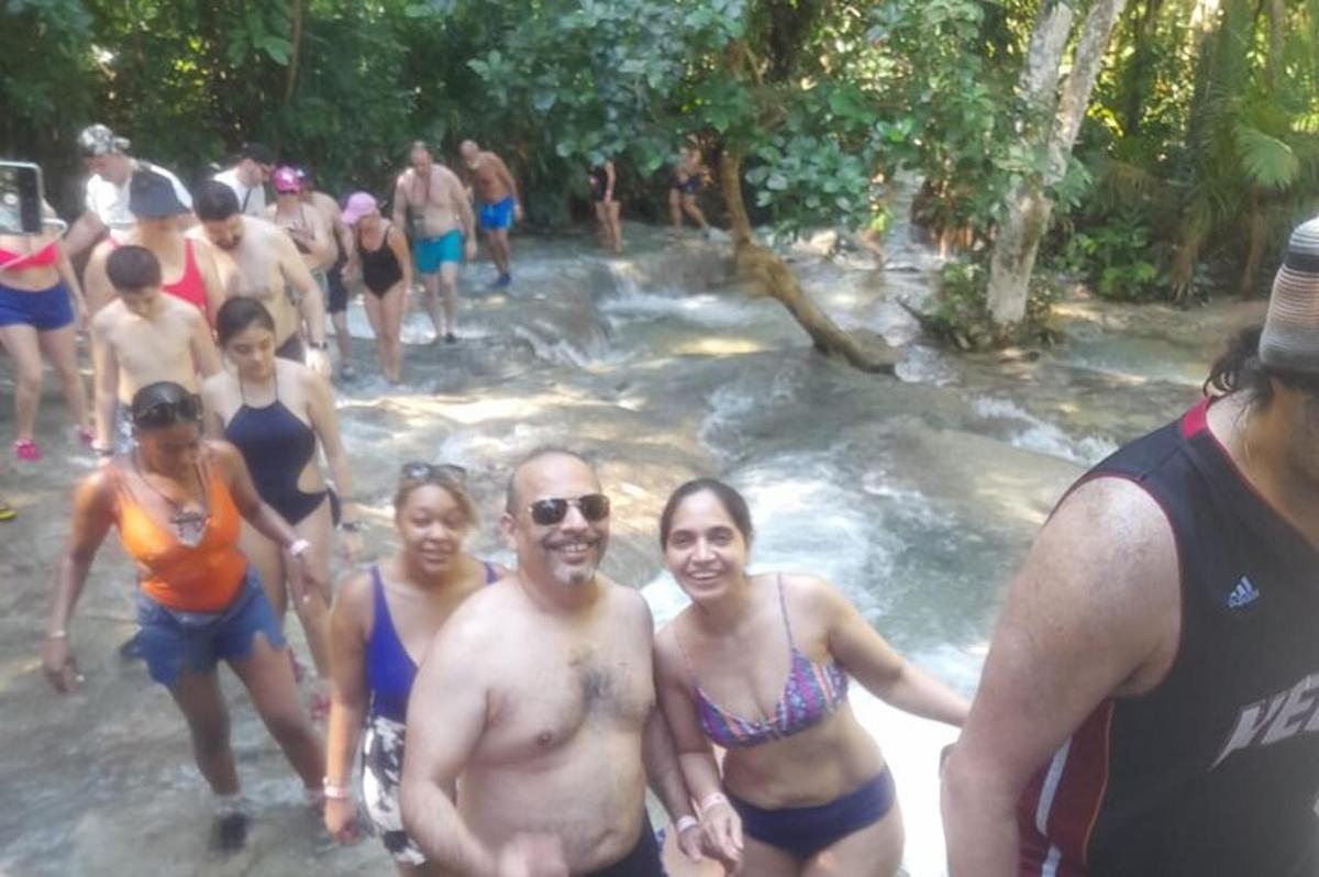 a group of people in bathing suits in a river