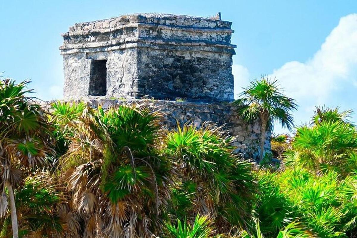 an old building with palm trees in front of it
