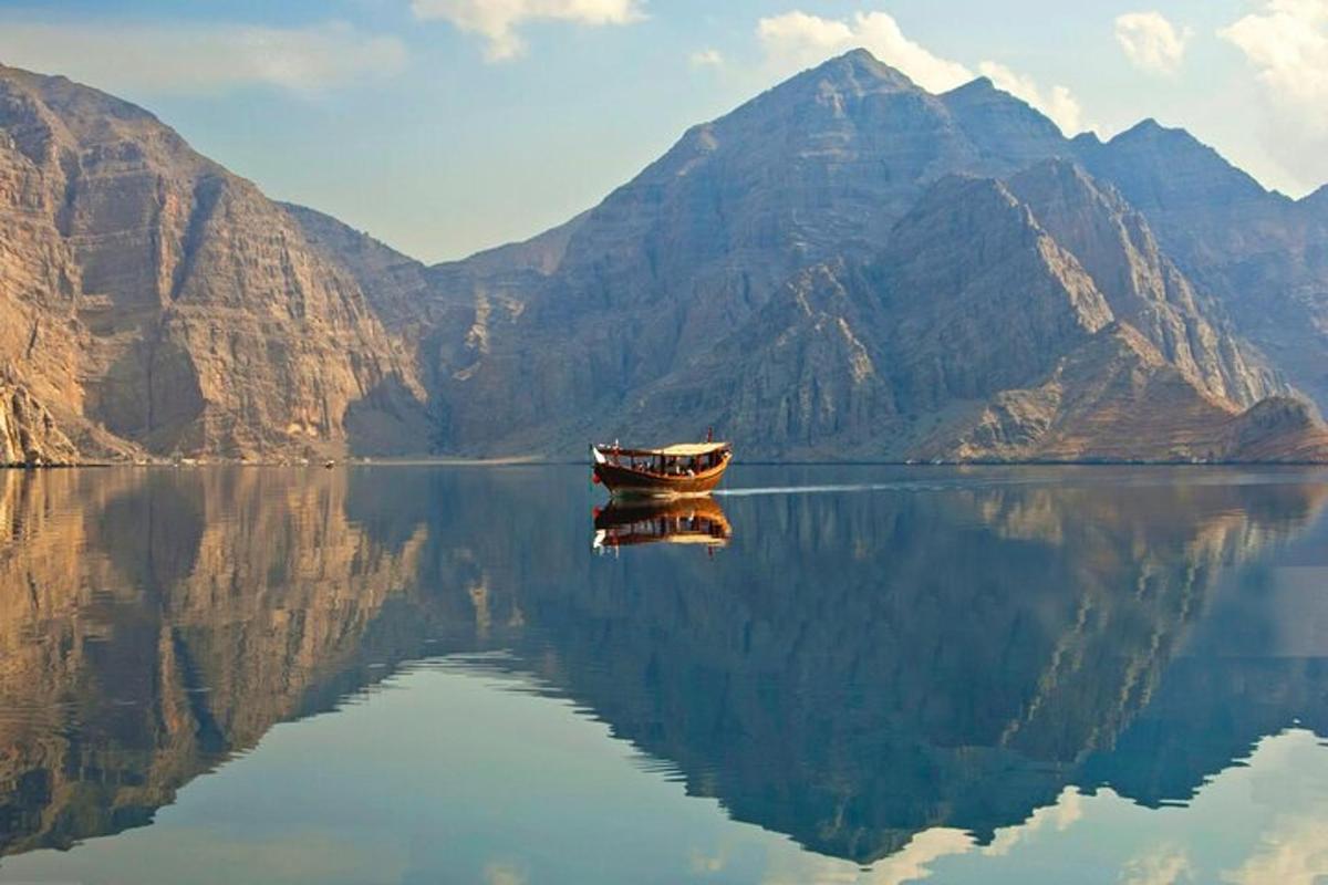 a boat on a body of water with mountains