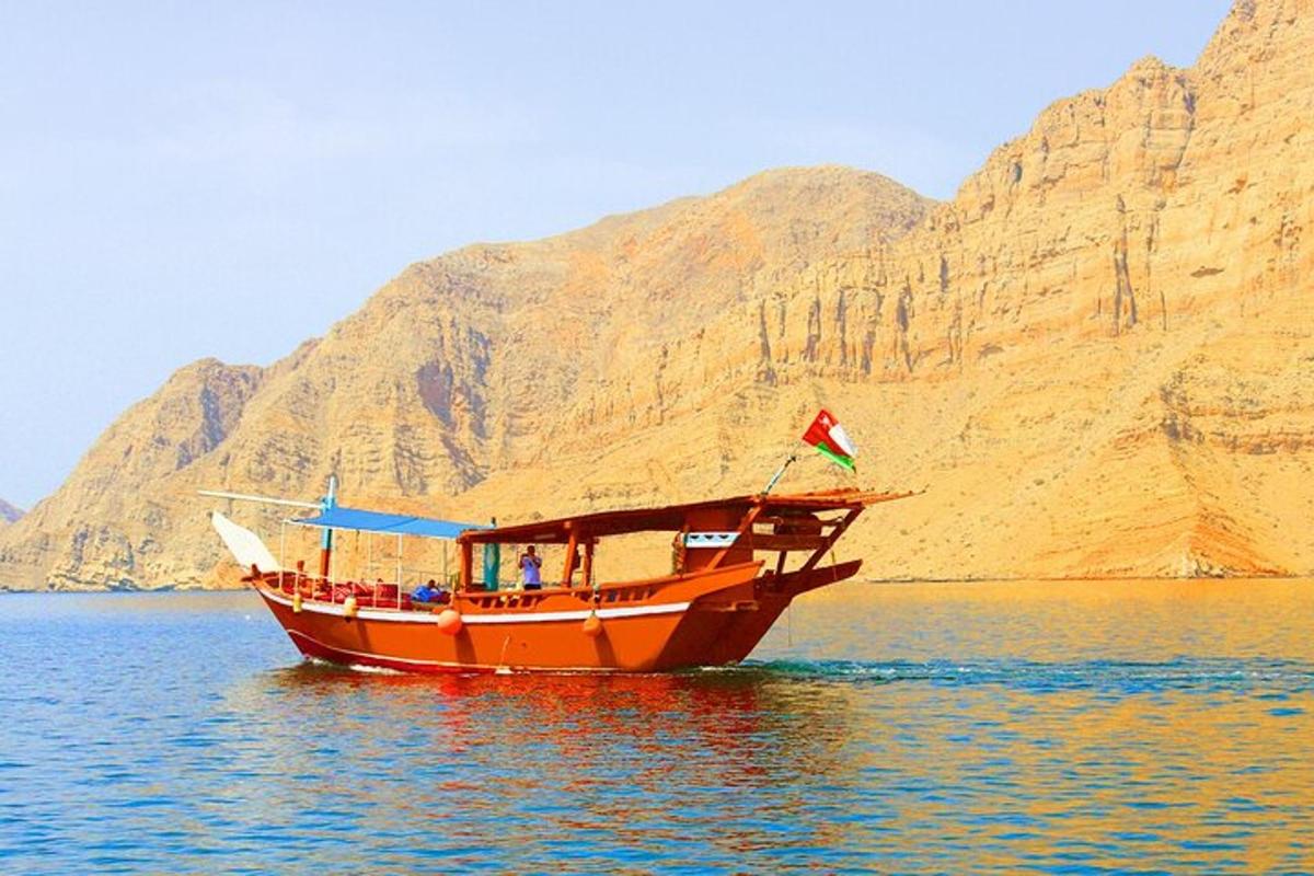 a boat on the water in front of a mountain