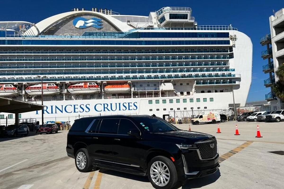 a black limousine parked in front of a cruise ship