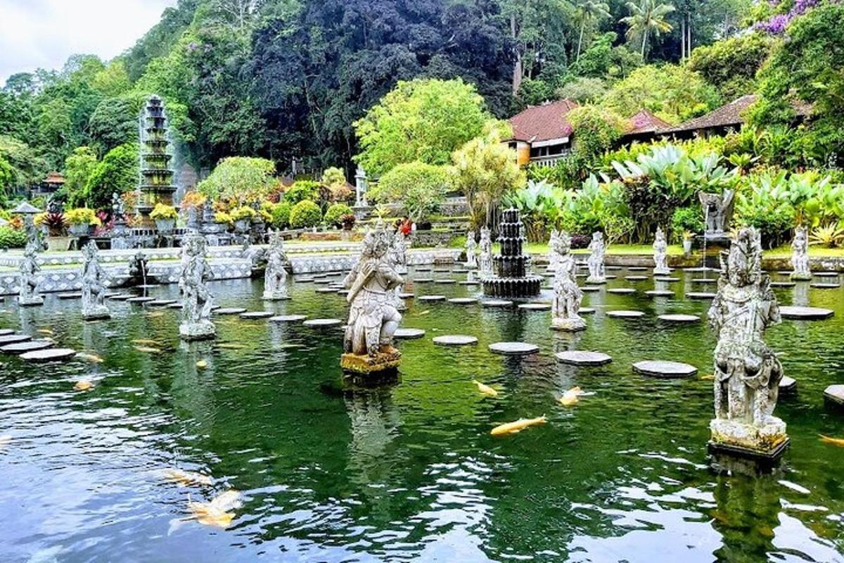 a garden with statues in the middle of a pond
