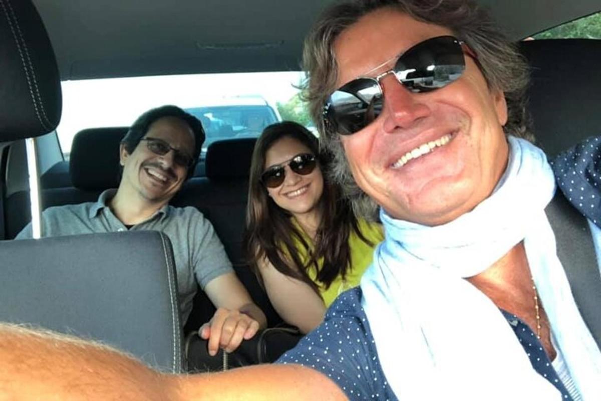 un grup de trei persoane care stau într-o mașină