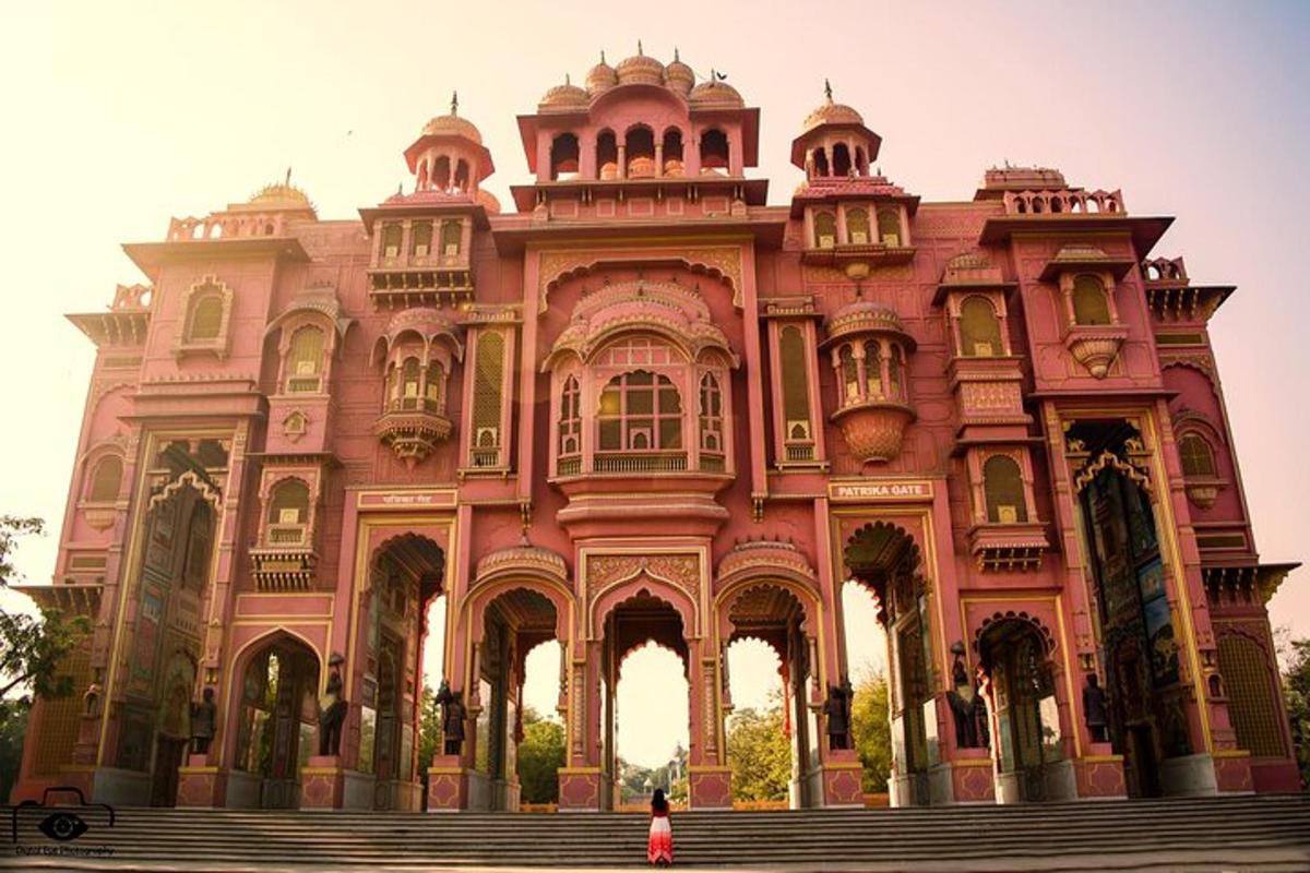 a woman standing in front of a pink building