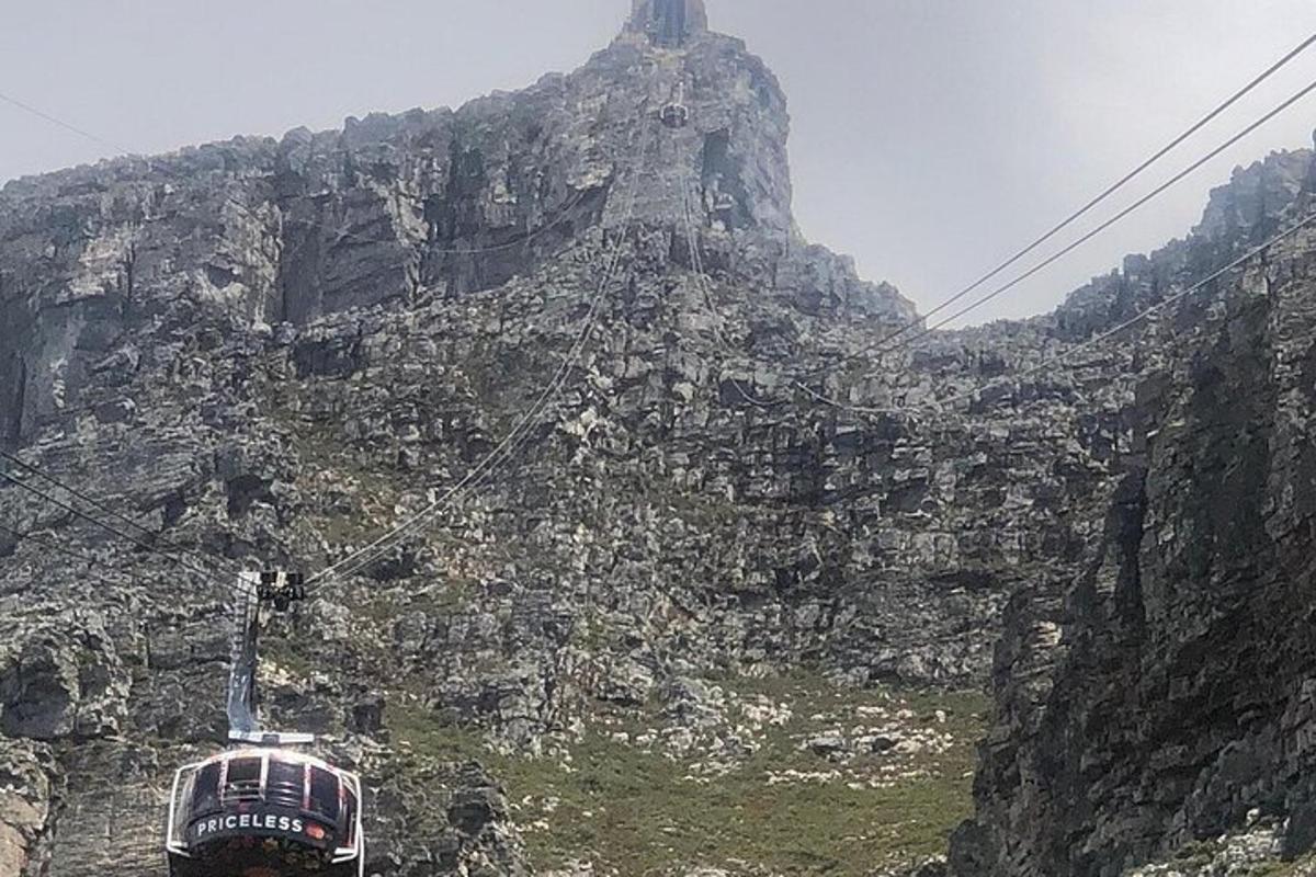 a bus on a mountain with a rock face