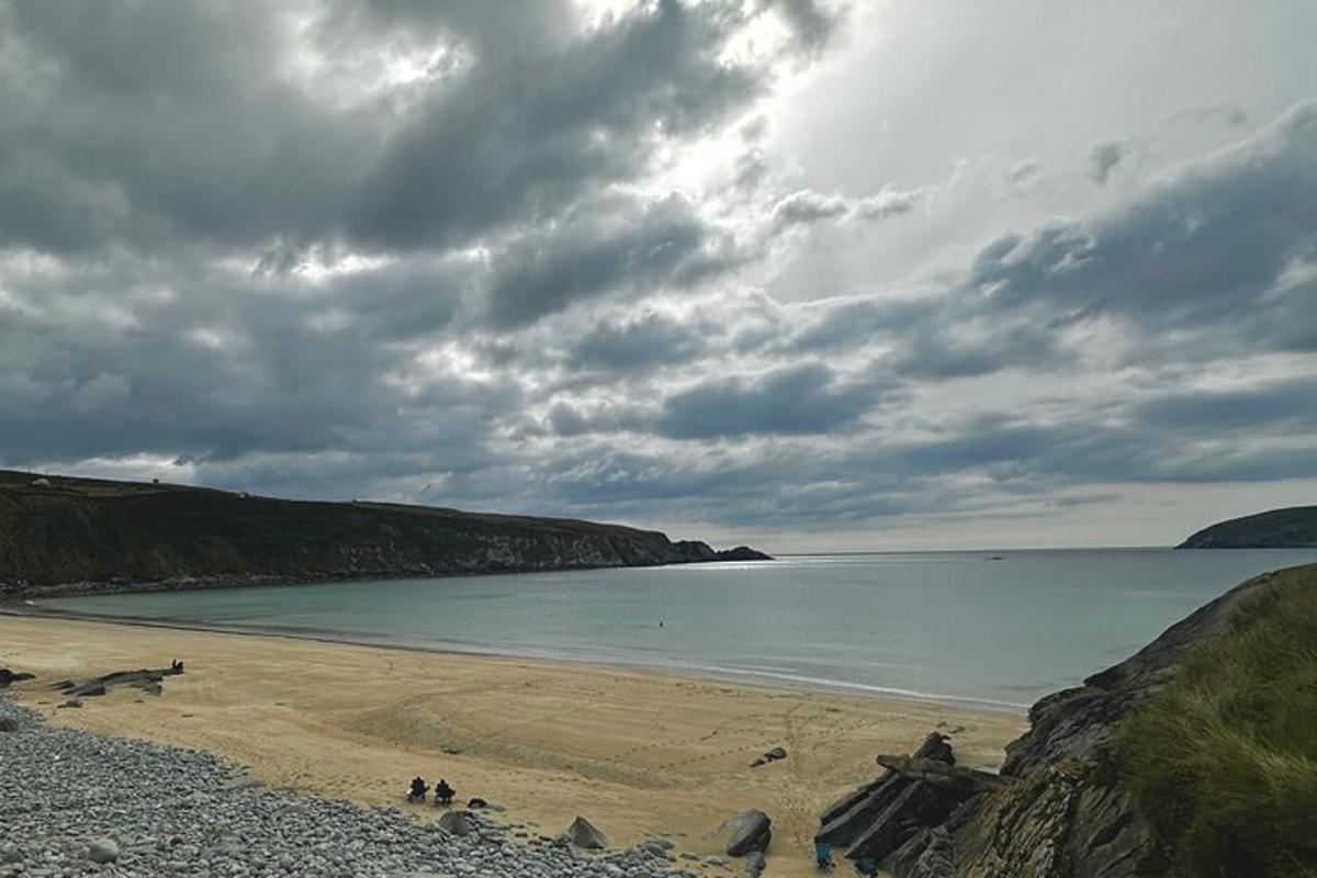 a beach with people on the sand and the water