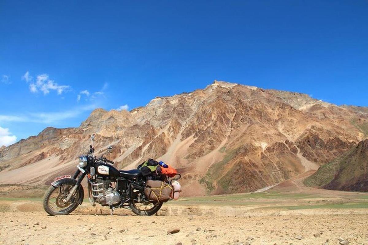 a motorcycle parked in front of a mountain