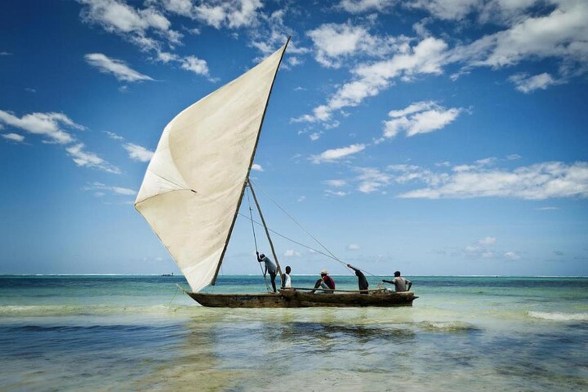 a group of people on a sail boat in the ocean