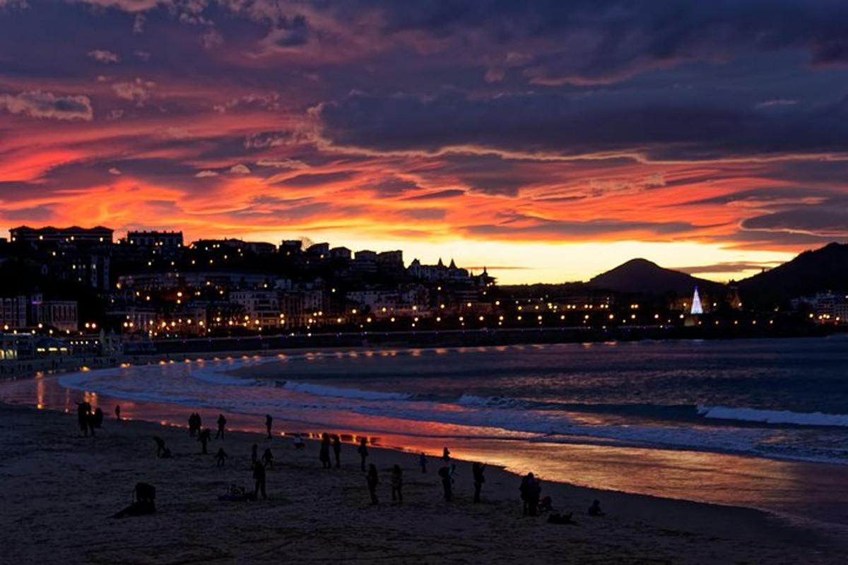 a group of people on the beach at sunset