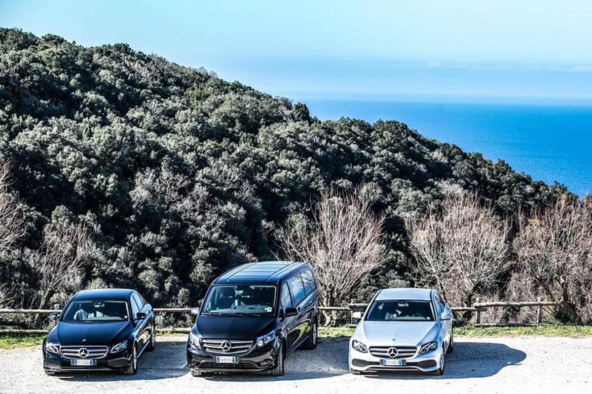 three cars parked in a parking lot near the ocean