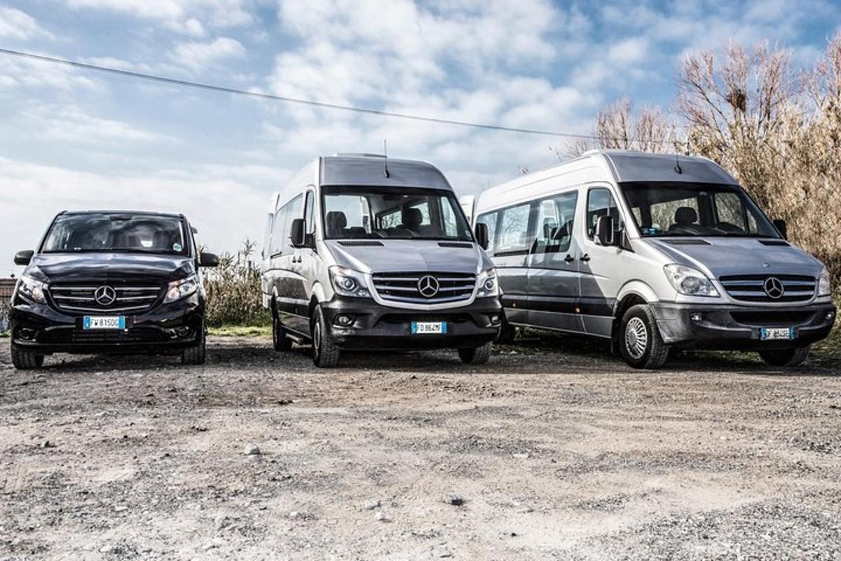 three vans parked next to each other in a parking lot