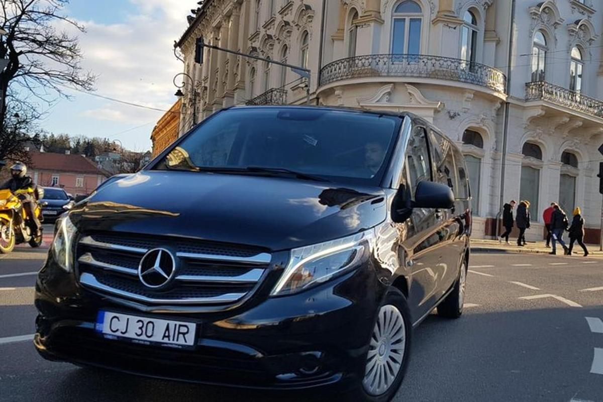 a black mercedes benz van parked on a city street