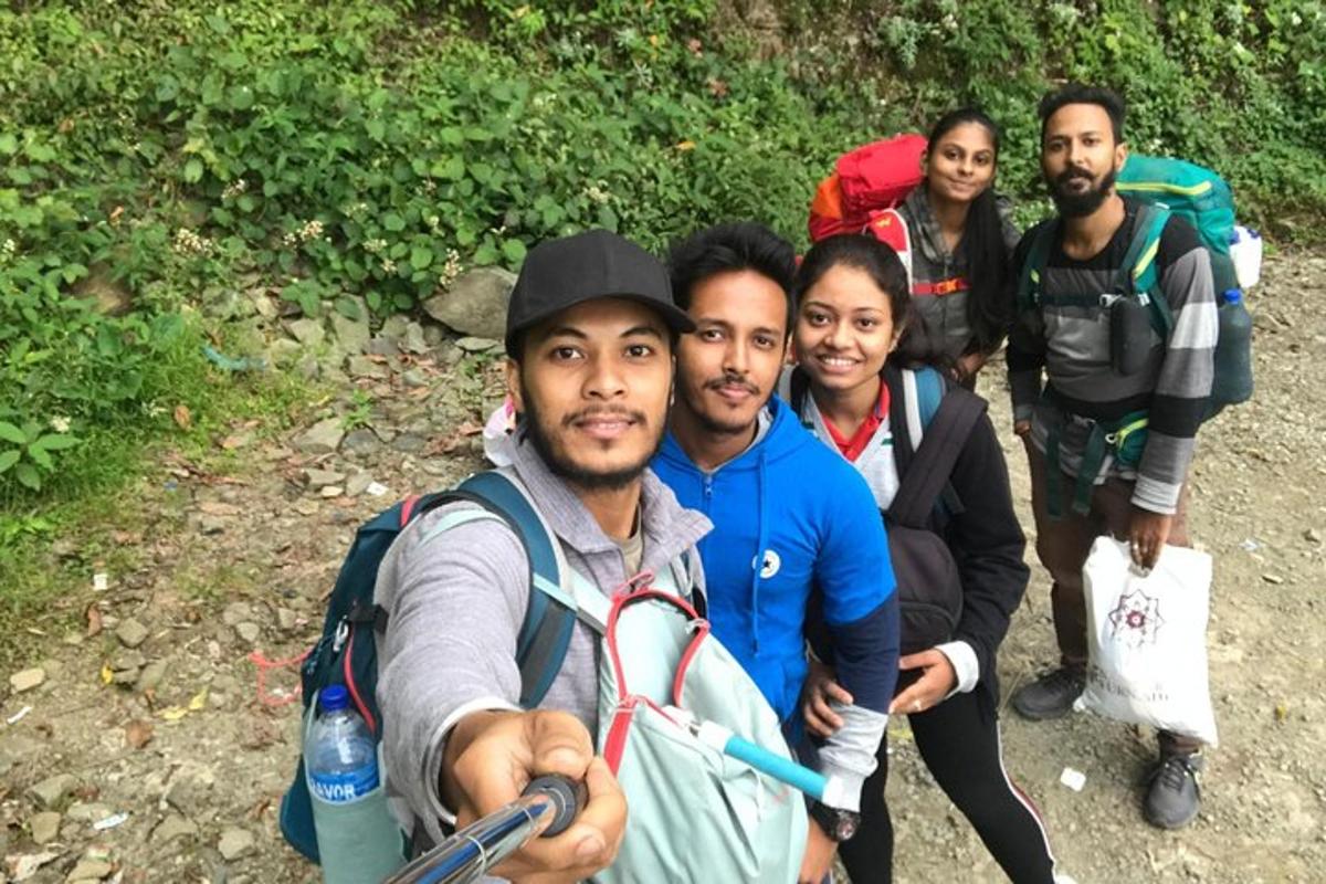 a group of people posing for a picture on a trail