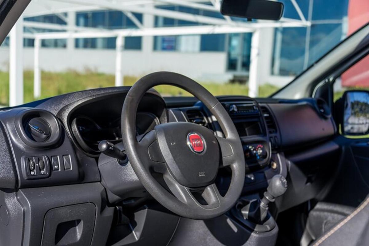 a dashboard of a car with a steering wheel