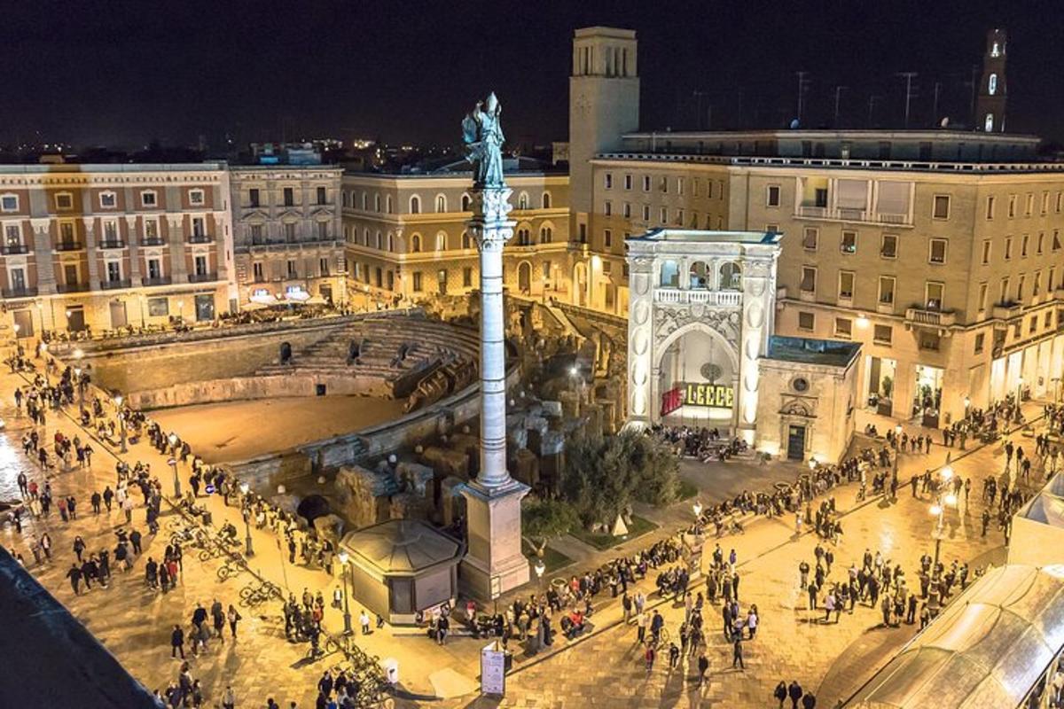 a city with a statue in front of a building
