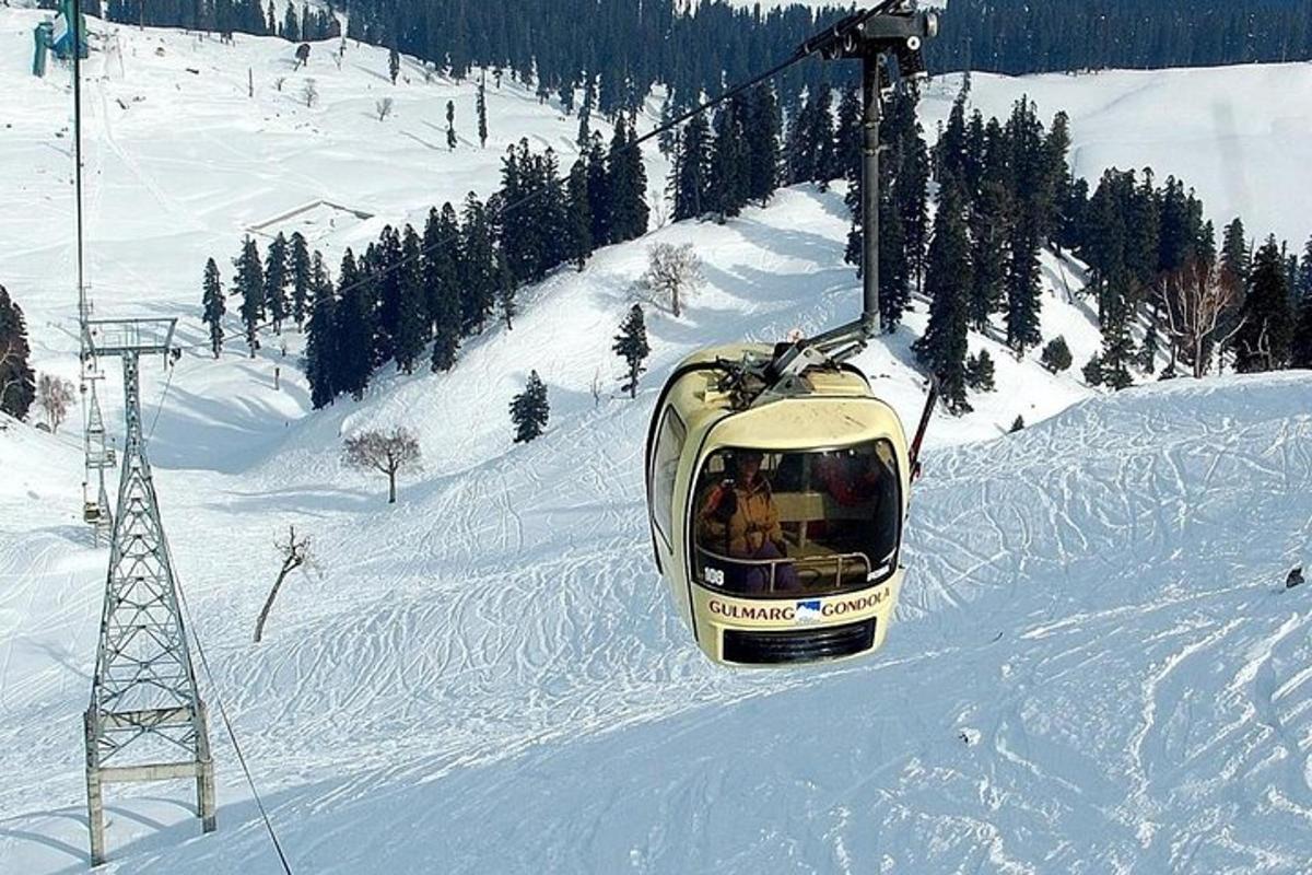a ski lift going up a snow covered mountain