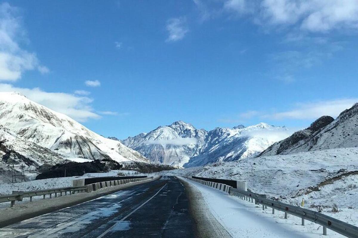 a road in the middle of a snow covered mountain
