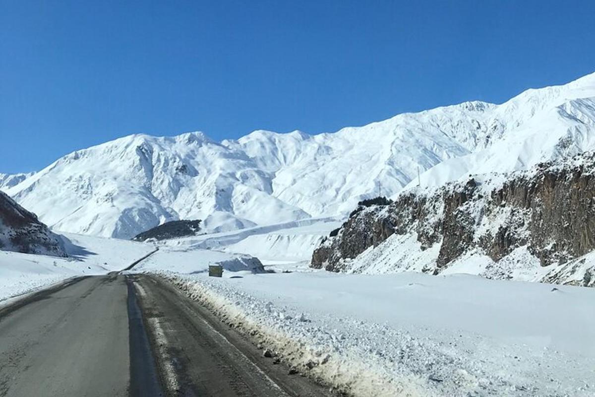 a road in the middle of a snow covered mountain
