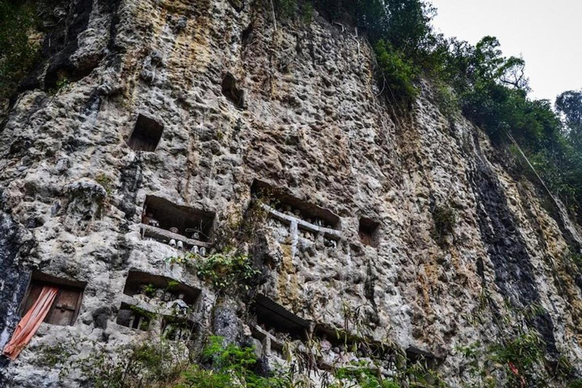 a stone building with windows on a mountain