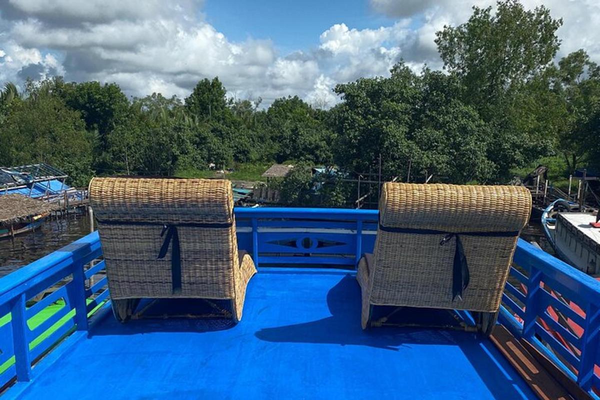 two wicker chairs sitting on the top of a deck
