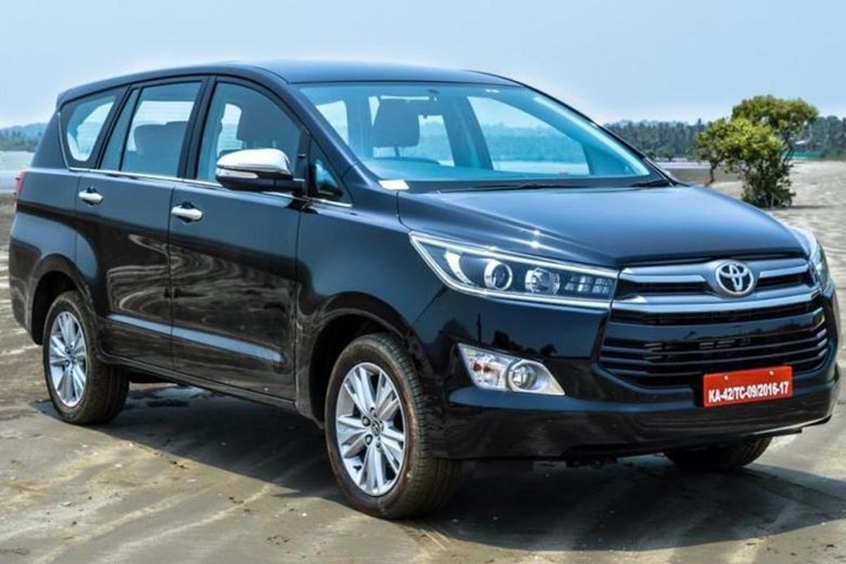 a blue toyota fortuner parked on the beach