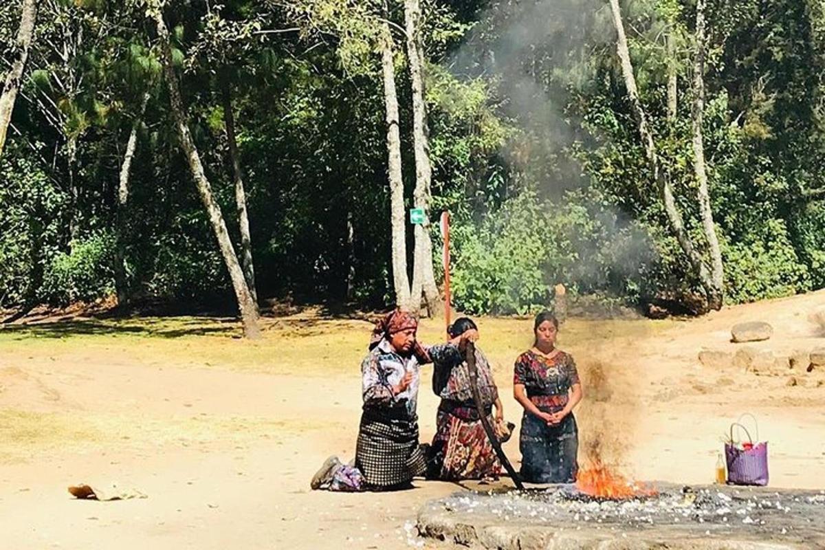 a group of three women standing next to a fire