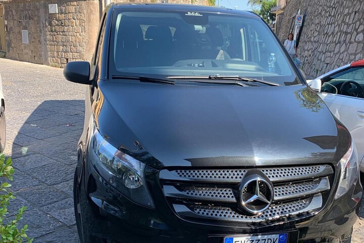 um carro preto estacionado na beira de uma rua