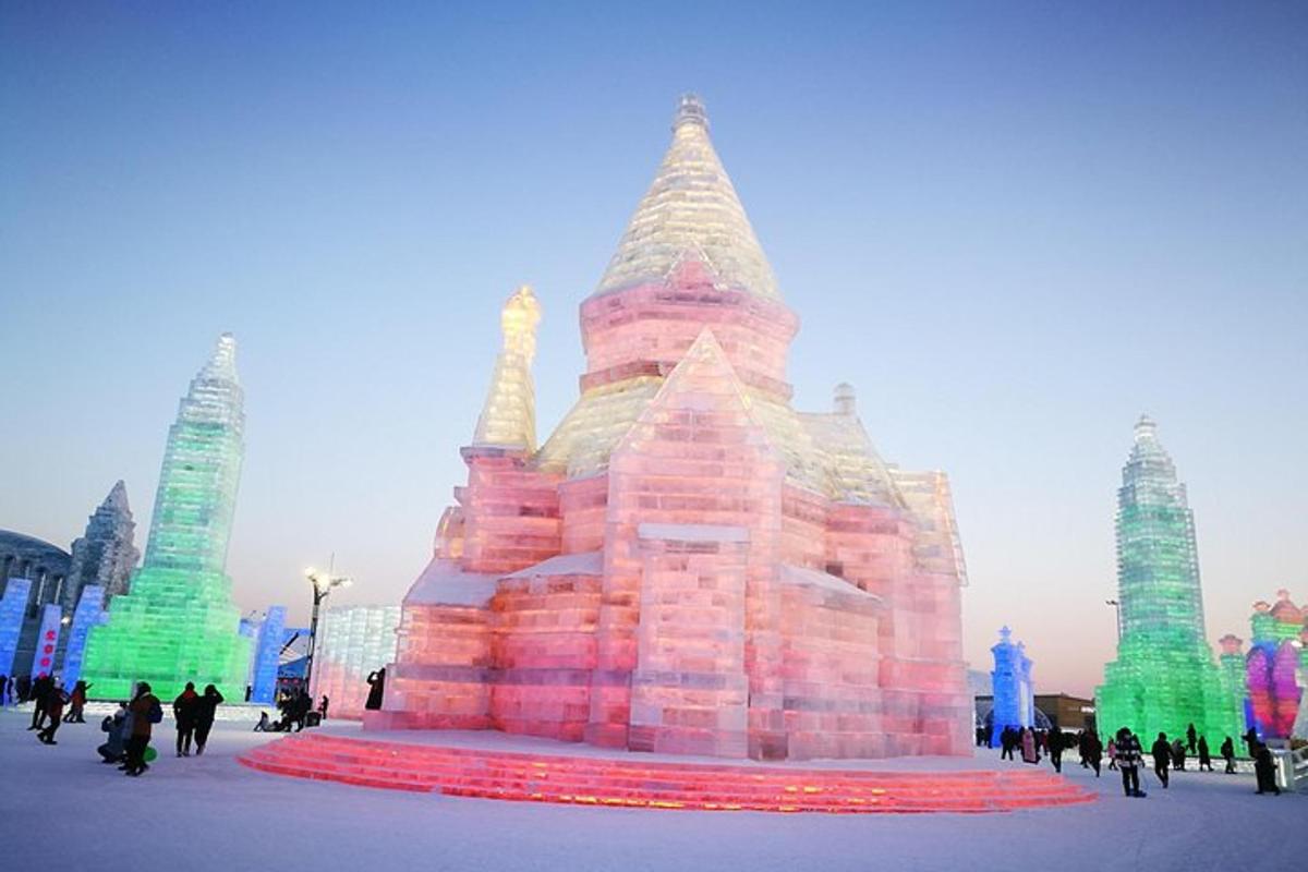 a large ice castle with people walking around it