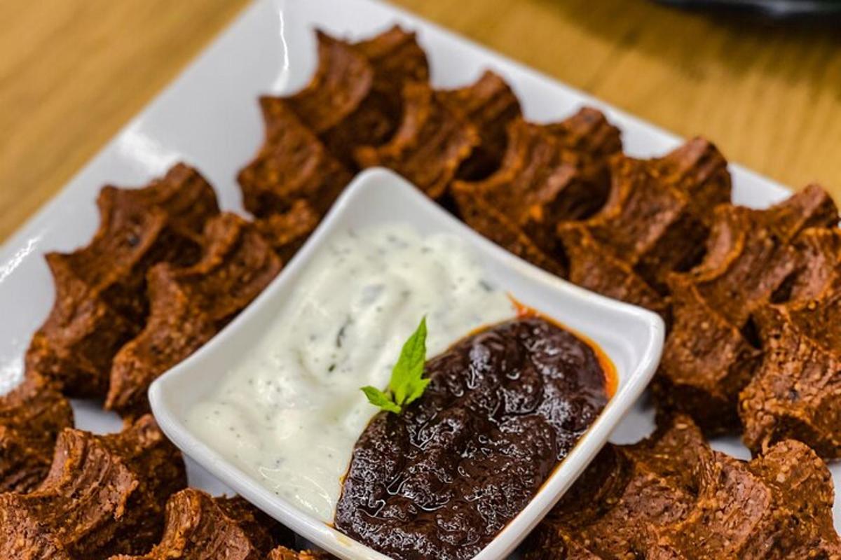 a plate of food with a small dish of dip
