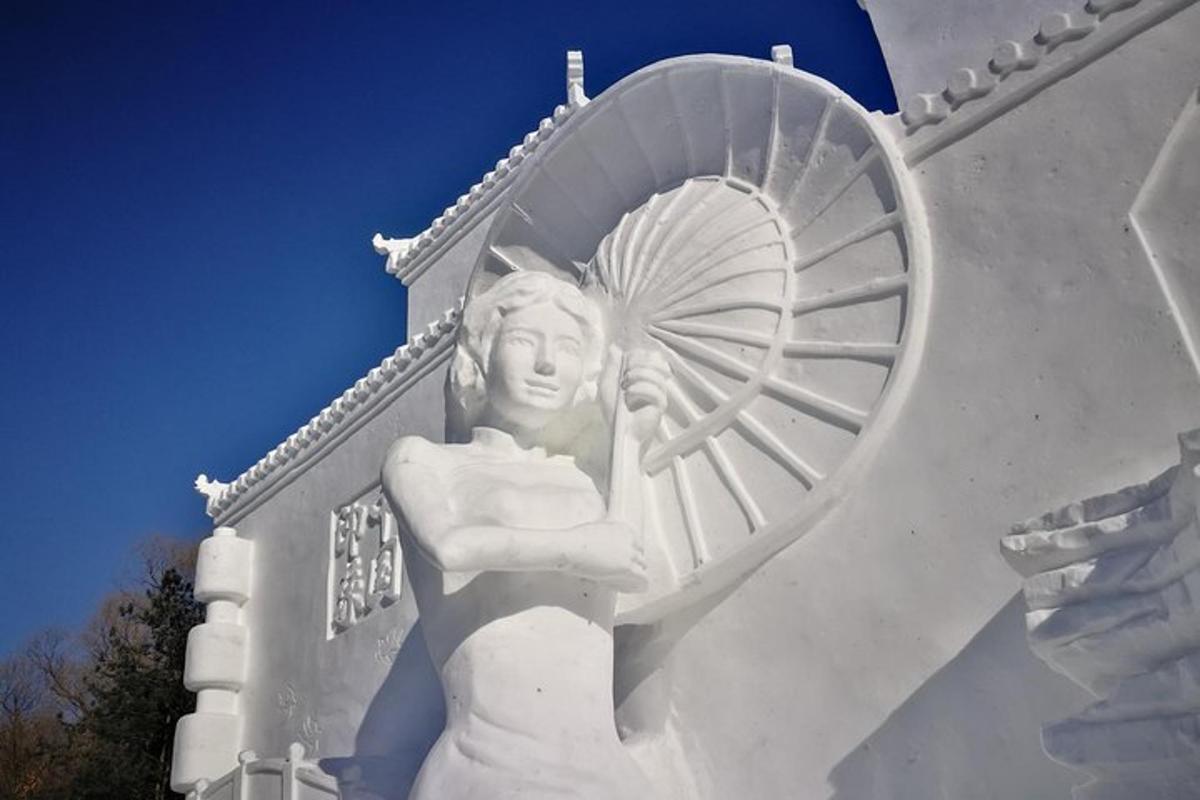 a statue of a woman on the side of a building