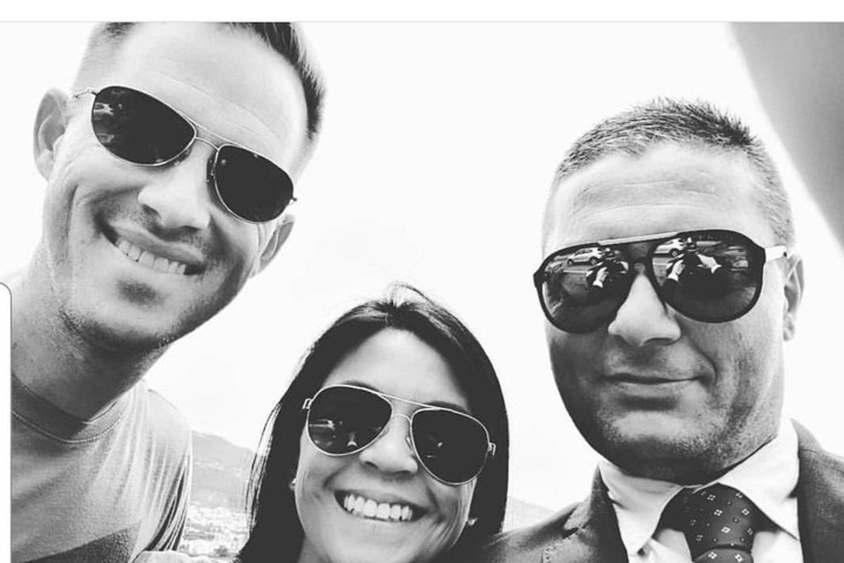 two men and a woman wearing sunglasses posing for a picture
