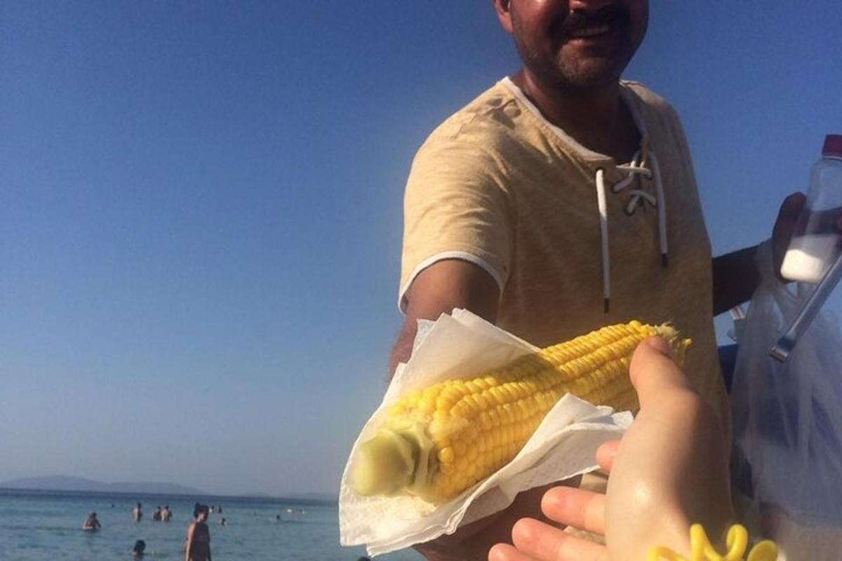 Ένας άντρας κρατάει ένα καλαμπόκι στο στάχυ