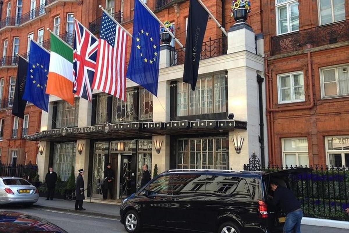 un'auto nera parcheggiata davanti a un edificio con bandiere